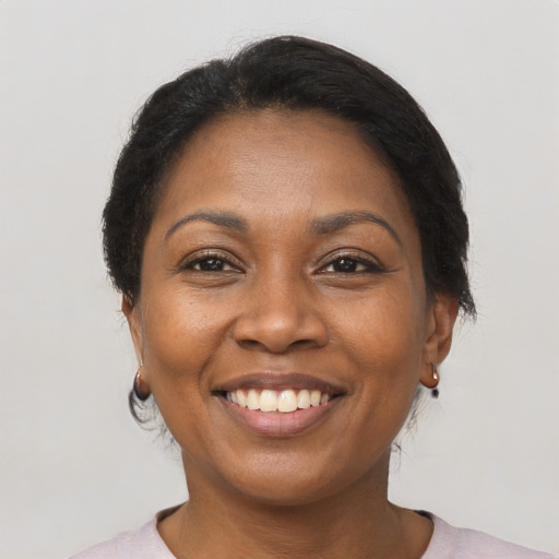 Joyful black adult female with short  brown hair and brown eyes