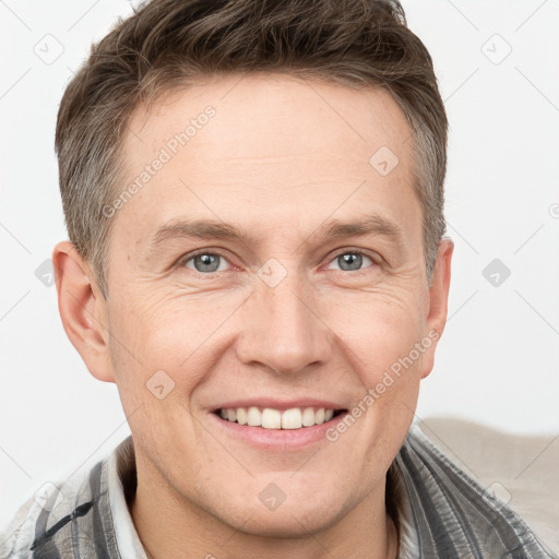 Joyful white adult male with short  brown hair and grey eyes