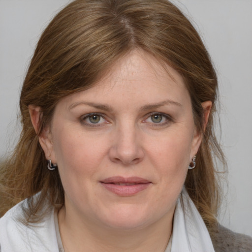 Joyful white adult female with medium  brown hair and blue eyes