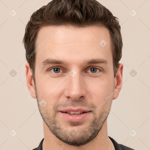 Joyful white young-adult male with short  brown hair and grey eyes