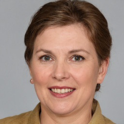 Joyful white adult female with medium  brown hair and grey eyes