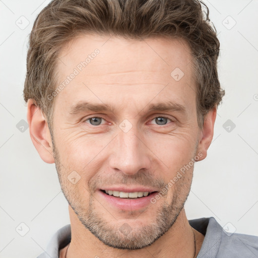 Joyful white adult male with short  brown hair and grey eyes