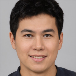 Joyful asian young-adult male with short  brown hair and brown eyes