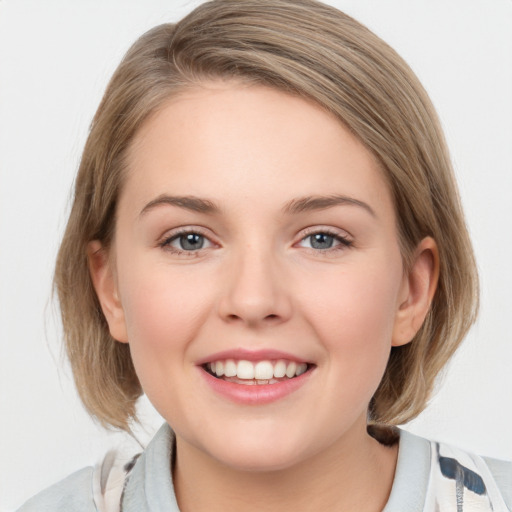 Joyful white young-adult female with medium  brown hair and blue eyes