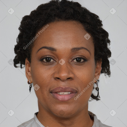 Joyful black adult female with short  brown hair and brown eyes