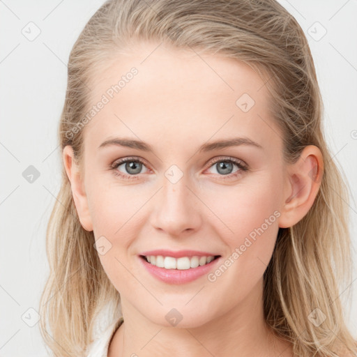 Joyful white young-adult female with long  brown hair and blue eyes