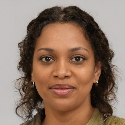 Joyful black young-adult female with medium  brown hair and brown eyes
