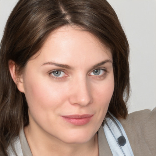 Joyful white young-adult female with medium  brown hair and grey eyes