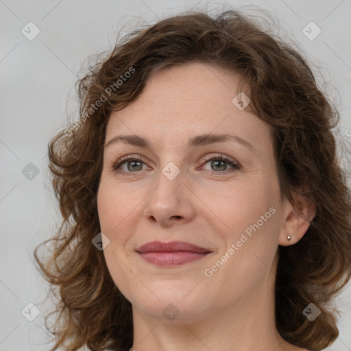 Joyful white young-adult female with medium  brown hair and green eyes