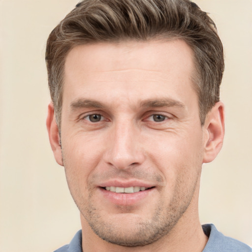 Joyful white adult male with short  brown hair and grey eyes