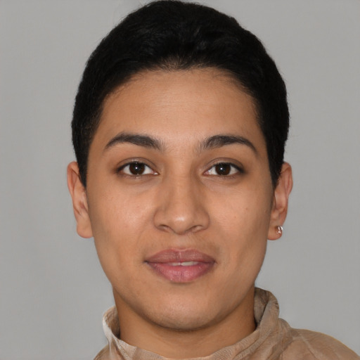 Joyful latino young-adult female with short  black hair and brown eyes