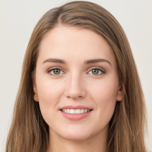 Joyful white young-adult female with long  brown hair and grey eyes