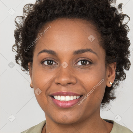 Joyful black young-adult female with short  brown hair and brown eyes