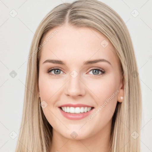 Joyful white young-adult female with long  brown hair and green eyes