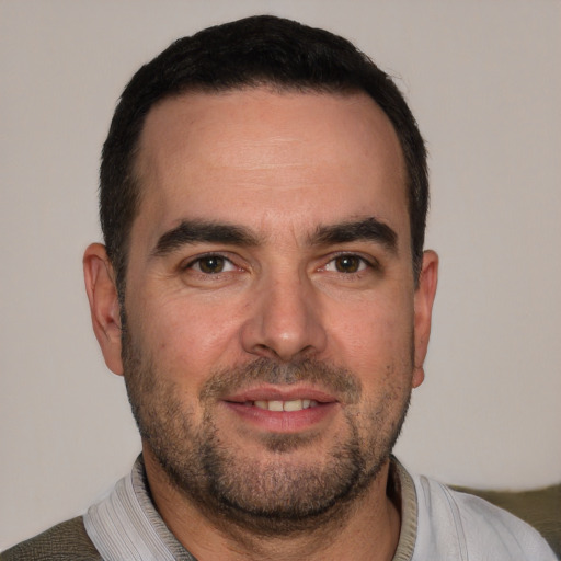 Joyful white young-adult male with short  black hair and brown eyes