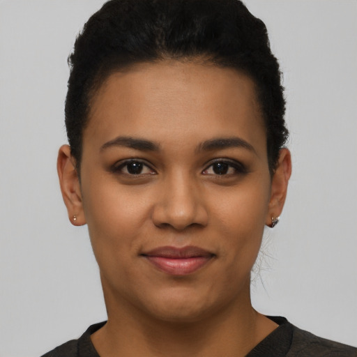 Joyful latino young-adult female with short  black hair and brown eyes