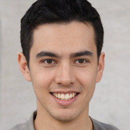 Joyful latino young-adult male with short  brown hair and brown eyes