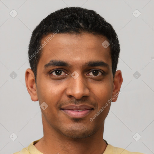 Joyful black young-adult male with short  black hair and brown eyes