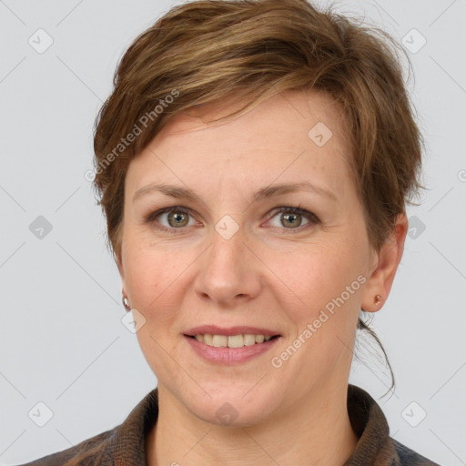 Joyful white adult female with medium  brown hair and grey eyes