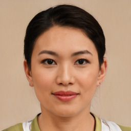 Joyful asian young-adult female with medium  black hair and brown eyes