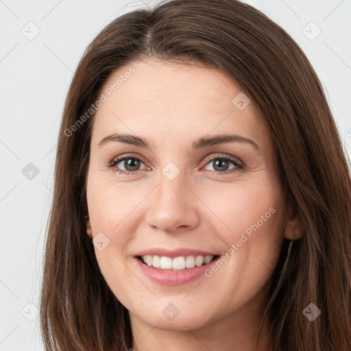 Joyful white young-adult female with long  brown hair and brown eyes