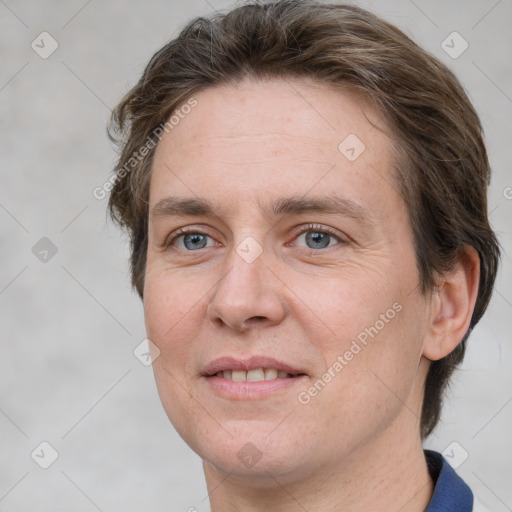 Joyful white adult female with short  brown hair and grey eyes