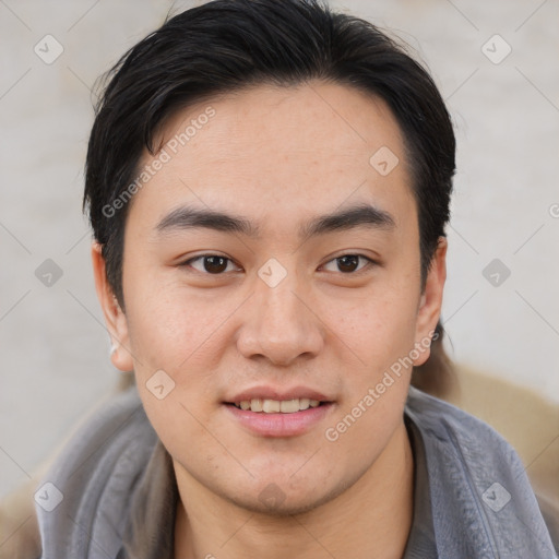 Joyful asian young-adult male with short  brown hair and brown eyes