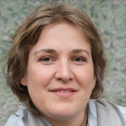 Joyful white adult female with medium  brown hair and brown eyes