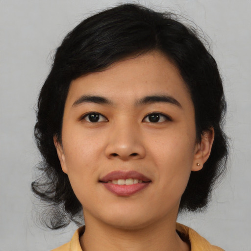 Joyful asian young-adult female with medium  black hair and brown eyes