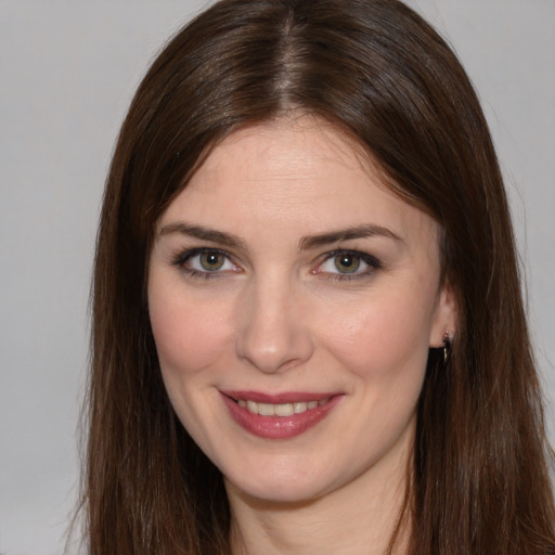 Joyful white young-adult female with long  brown hair and brown eyes