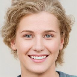 Joyful white young-adult female with medium  brown hair and blue eyes