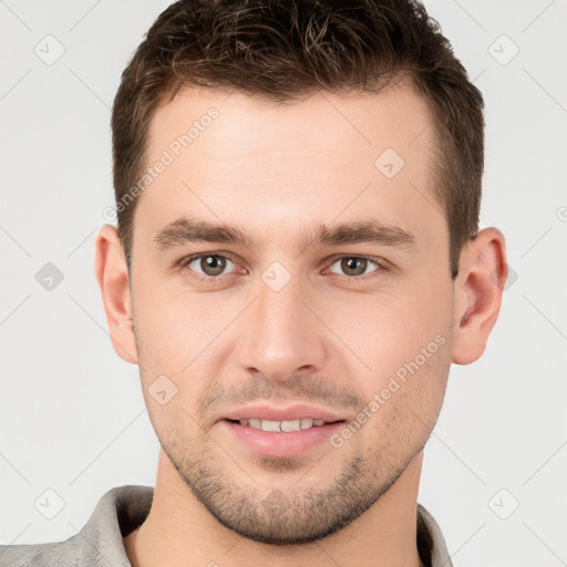 Joyful white young-adult male with short  brown hair and brown eyes