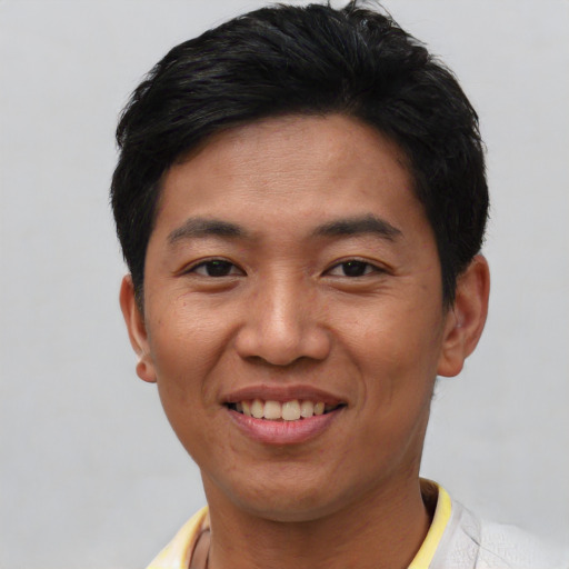 Joyful asian young-adult male with short  black hair and brown eyes