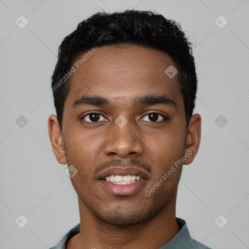 Joyful black young-adult male with short  black hair and brown eyes