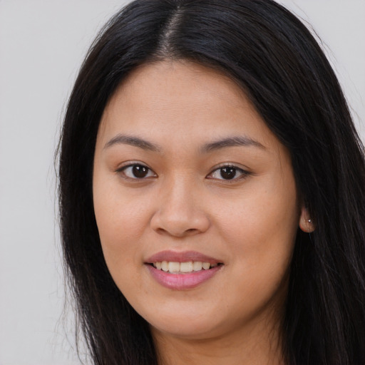 Joyful asian young-adult female with long  brown hair and brown eyes