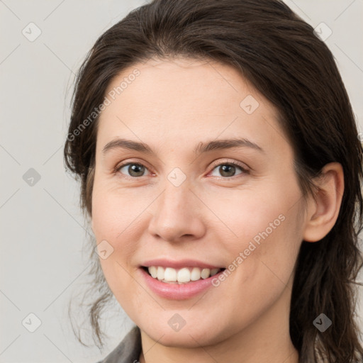 Joyful white young-adult female with medium  brown hair and grey eyes