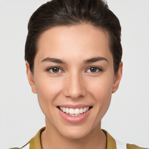 Joyful white young-adult female with short  brown hair and brown eyes