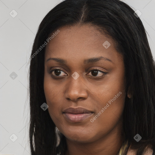 Joyful black young-adult female with long  brown hair and brown eyes