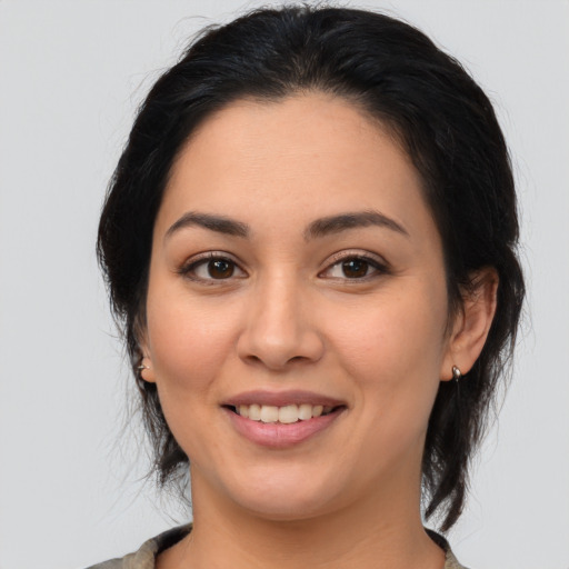 Joyful latino young-adult female with medium  brown hair and brown eyes