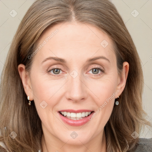 Joyful white adult female with medium  brown hair and grey eyes