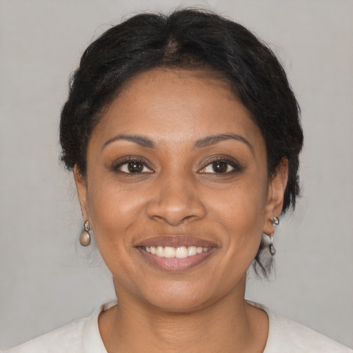 Joyful black young-adult female with medium  brown hair and brown eyes