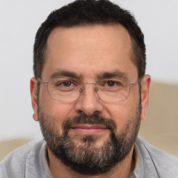 Joyful white adult male with short  brown hair and brown eyes