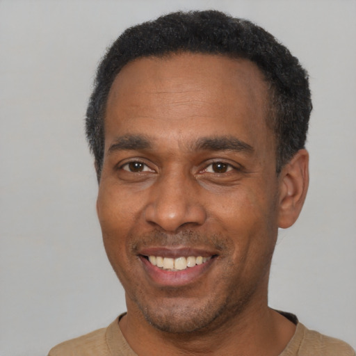 Joyful latino adult male with short  black hair and brown eyes
