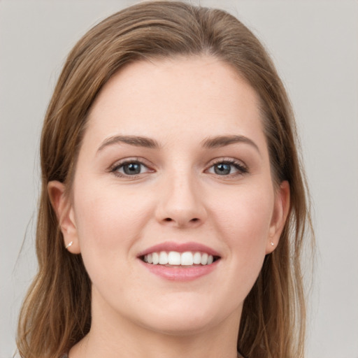 Joyful white young-adult female with long  brown hair and grey eyes