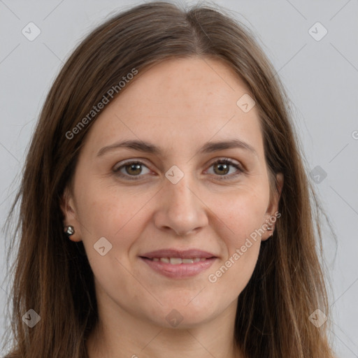 Joyful white adult female with long  brown hair and brown eyes