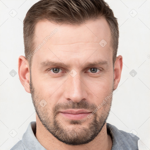 Joyful white young-adult male with short  brown hair and grey eyes