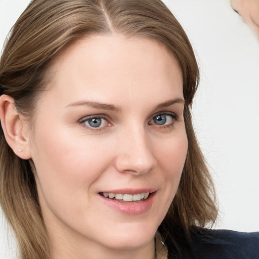 Joyful white young-adult female with long  brown hair and blue eyes