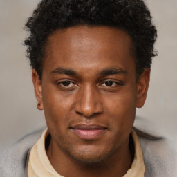 Joyful black young-adult male with short  brown hair and brown eyes
