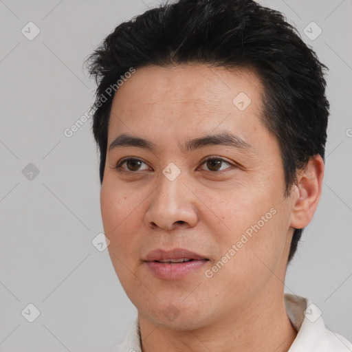 Joyful white adult male with short  black hair and brown eyes