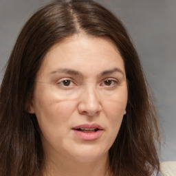 Joyful white adult female with medium  brown hair and brown eyes